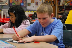 Logan works extremely hard on his quilt square.