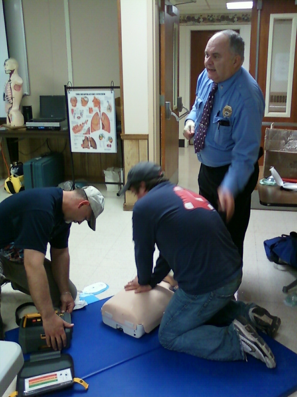 Fred instructing Leon and Jeremiah during AED practice.